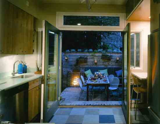 Metalsmith Charles Danley crafted a fireplace that functions as a cookstove and provides heat to extend the patio’s usefulness into cooler seasons.
